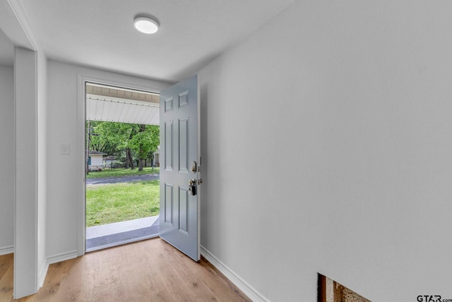 entrance foyer with baseboards and light wood-type flooring
