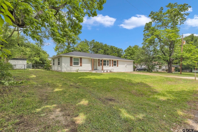 single story home featuring fence and a front yard