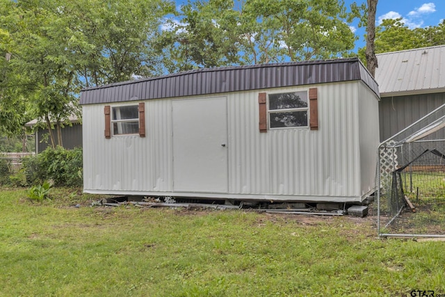 view of shed featuring fence