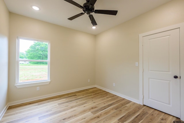 empty room featuring ceiling fan and light wood-type flooring