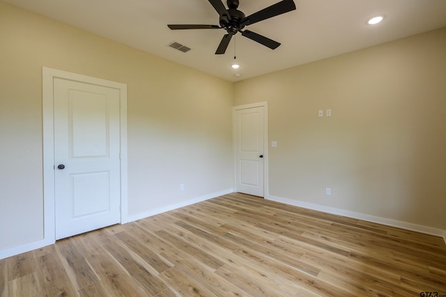 empty room with light wood-type flooring and ceiling fan