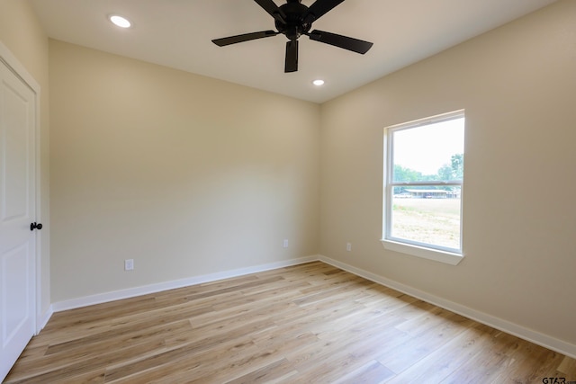 spare room with ceiling fan and light wood-type flooring