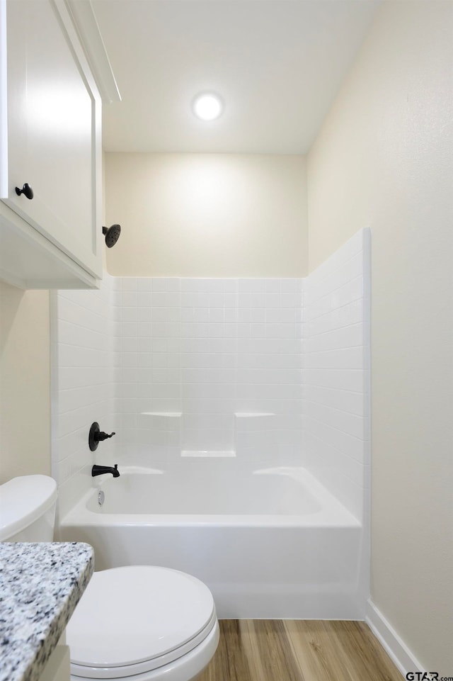 full bathroom featuring toilet, washtub / shower combination, vanity, and wood-type flooring