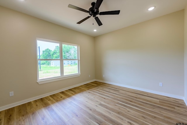 spare room featuring ceiling fan and light hardwood / wood-style flooring