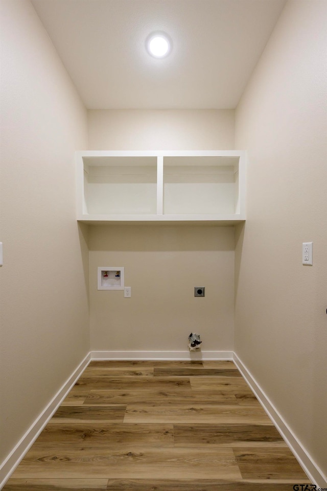 washroom with hardwood / wood-style flooring, hookup for a washing machine, and hookup for an electric dryer