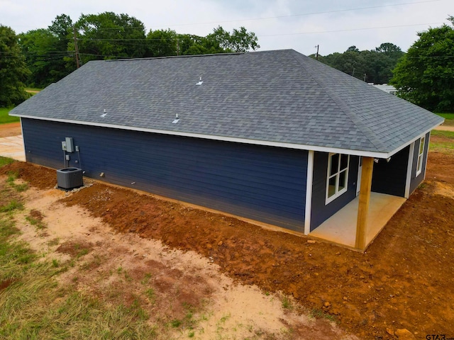 view of side of home with central AC unit