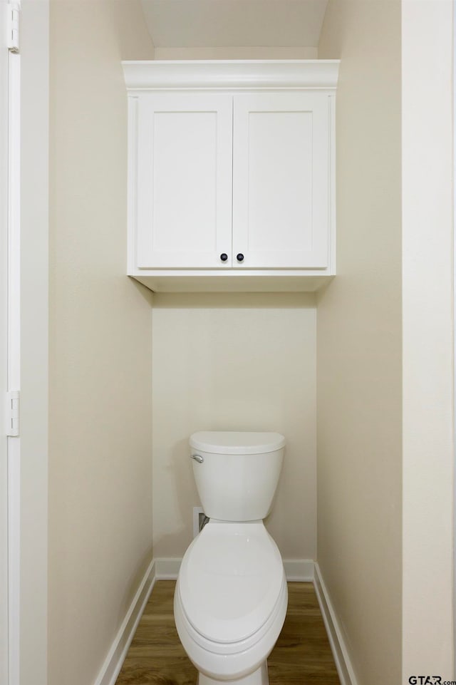 bathroom featuring toilet and wood-type flooring