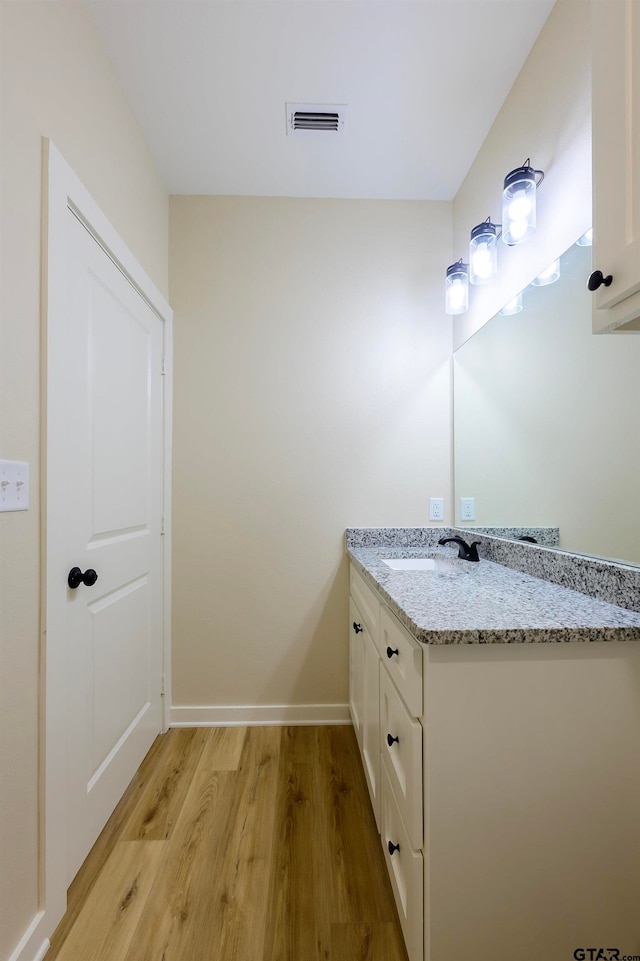 bathroom featuring vanity and wood-type flooring