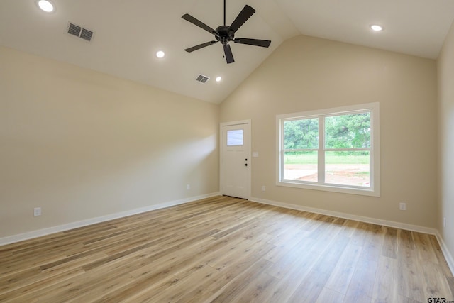 spare room with ceiling fan, light wood-type flooring, and high vaulted ceiling