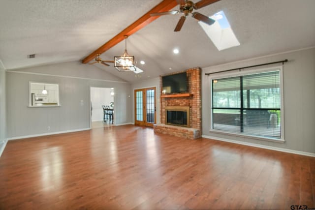 201 Karla Dr, Whitehouse, TX 75791 - unfurnished living room featuring a ceiling fan, wood finished floors, plenty of natural light, and a textured ceiling
