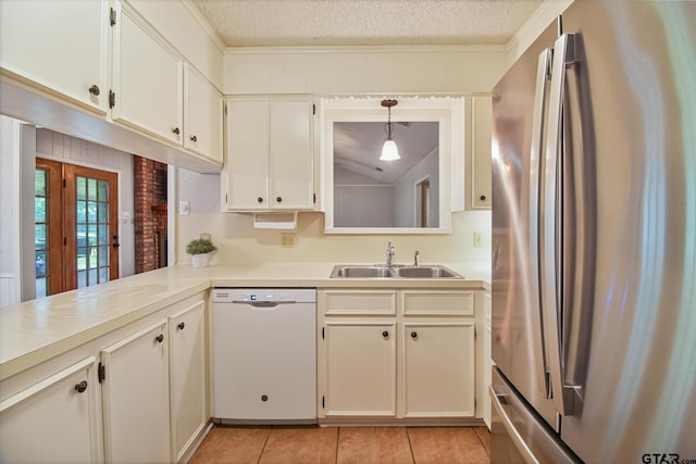 201 Karla Dr, Whitehouse, TX 75791 - kitchen with freestanding refrigerator, white dishwasher, light countertops, light tile patterned flooring, and a textured ceiling