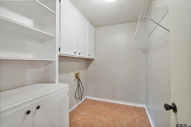 201 Karla Dr, Whitehouse, TX 75791 - washroom featuring cabinet space, a textured ceiling, washer hookup, and light tile patterned floors