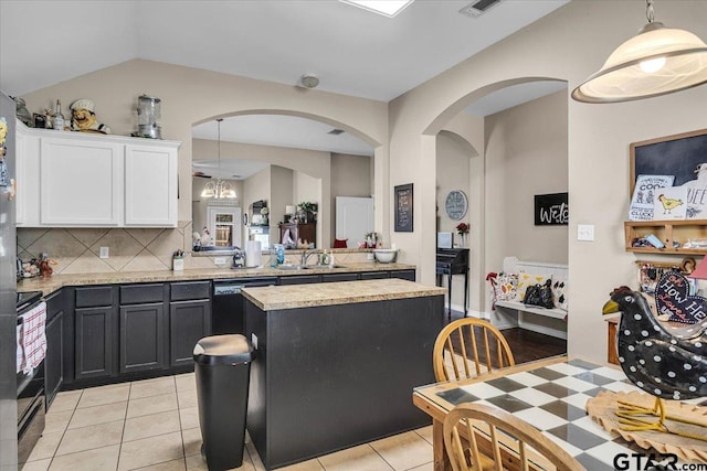 kitchen featuring a center island, dishwasher, stove, white cabinetry, and a sink