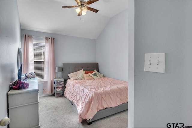 bedroom featuring vaulted ceiling, carpet flooring, and a ceiling fan