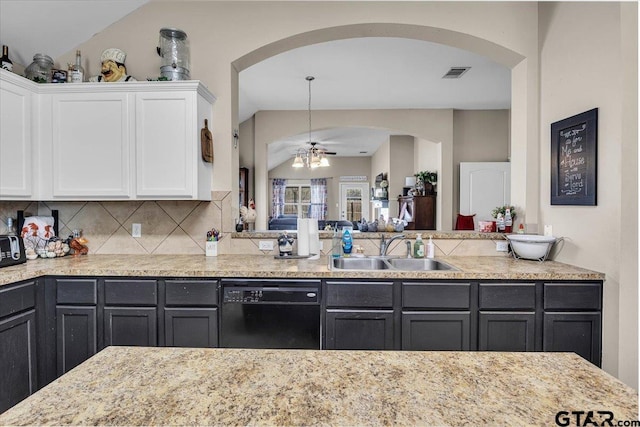 kitchen with visible vents, dishwasher, decorative backsplash, white cabinetry, and a sink