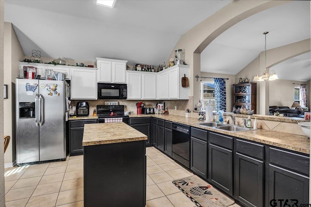 kitchen featuring a sink, black appliances, light tile patterned flooring, and vaulted ceiling