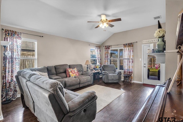 living room featuring baseboards, visible vents, lofted ceiling, dark wood-style flooring, and ceiling fan