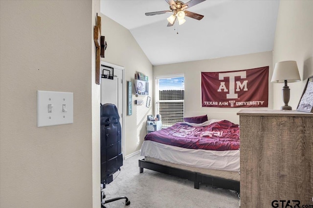 carpeted bedroom with baseboards, a ceiling fan, and vaulted ceiling