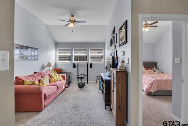 living room featuring baseboards, carpet, ceiling fan, and vaulted ceiling