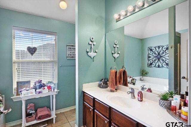 bathroom featuring tile patterned flooring, vanity, and baseboards