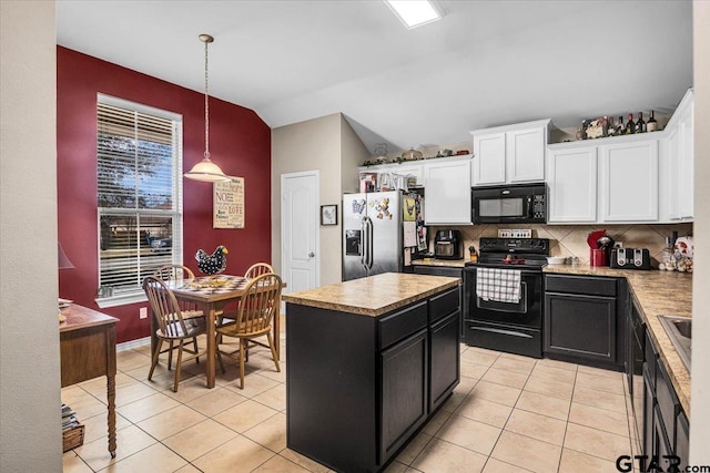 kitchen with black appliances, a kitchen island, white cabinetry, light tile patterned flooring, and dark cabinets