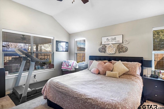 carpeted bedroom featuring lofted ceiling and a ceiling fan