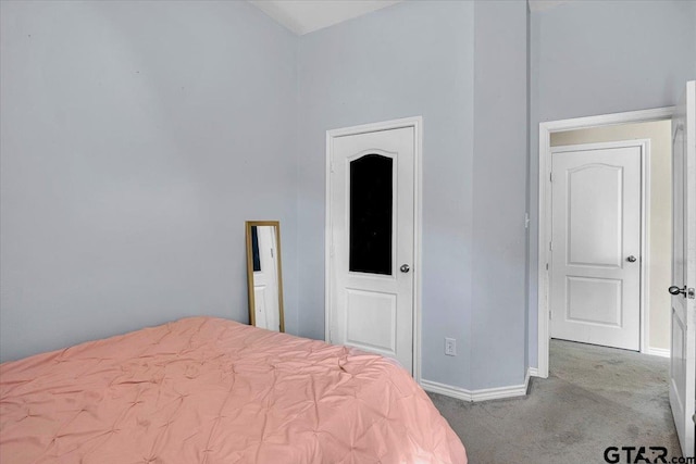 bedroom featuring baseboards and carpet