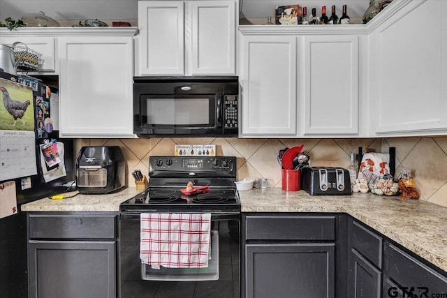 kitchen featuring black appliances, white cabinets, and light countertops