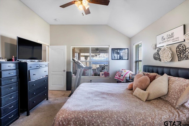 carpeted bedroom featuring lofted ceiling and a ceiling fan