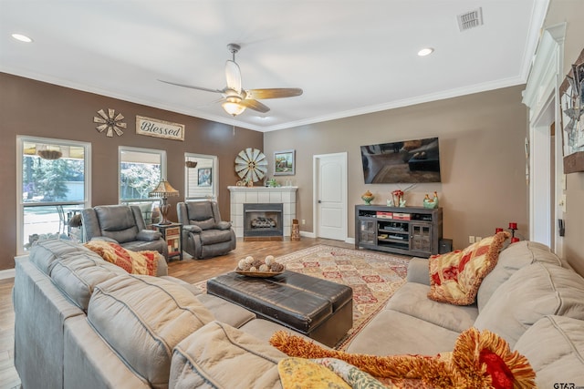 21105 Altuda Ln, Flint, TX 75762 - living room featuring ceiling fan, a tile fireplace, ornamental molding, wood finished floors, and recessed lighting