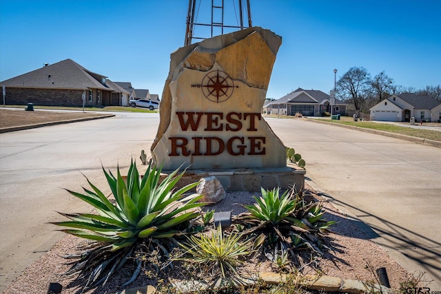 community / neighborhood sign with a residential view