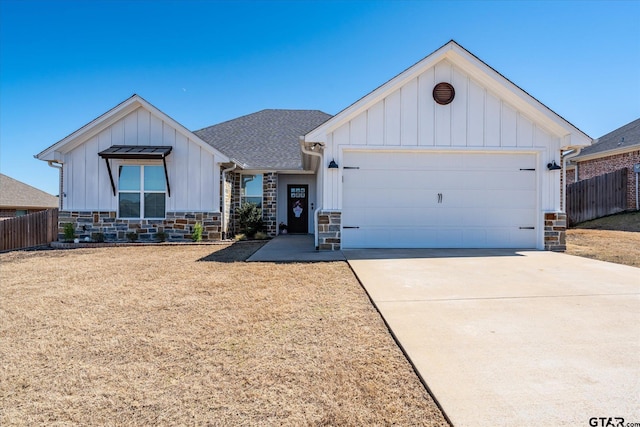 modern farmhouse style home with board and batten siding, driveway, a garage, and fence