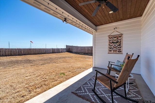 view of yard featuring a patio area, a fenced backyard, and a ceiling fan