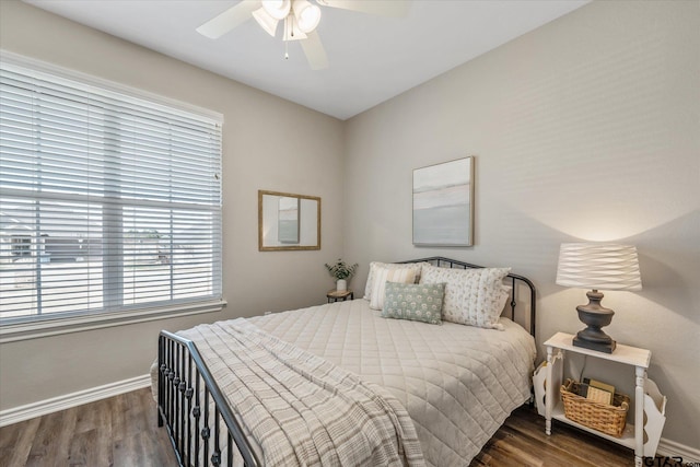 bedroom featuring a ceiling fan, baseboards, and wood finished floors