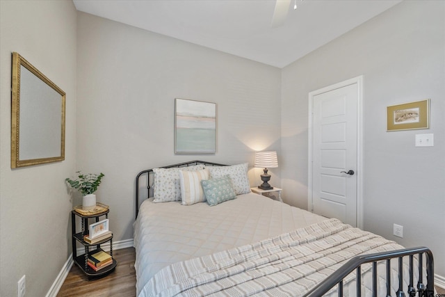 bedroom with ceiling fan, wood finished floors, and baseboards