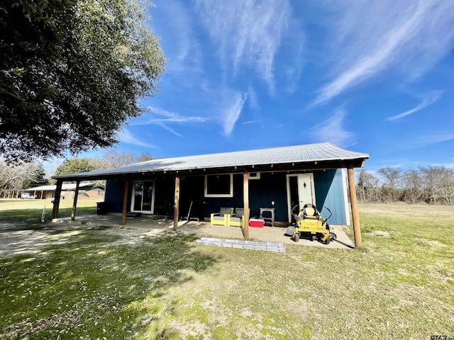 view of front of house with a front lawn and a patio area