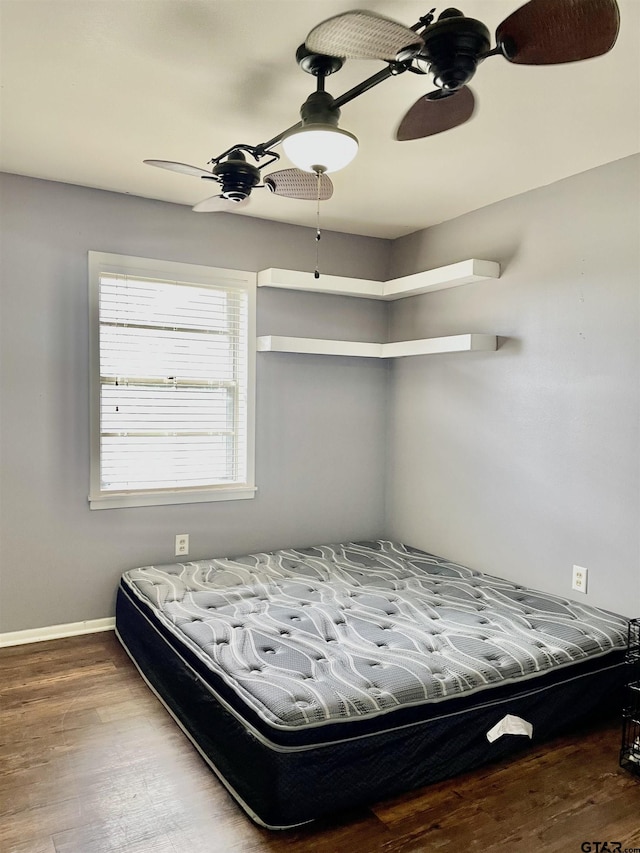 bedroom featuring ceiling fan and wood-type flooring