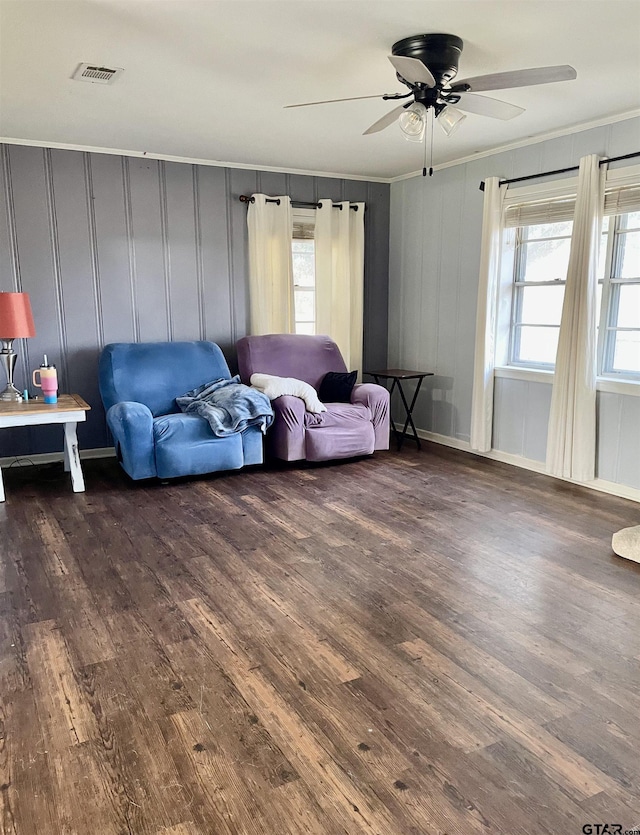 living room with ceiling fan, a wealth of natural light, crown molding, and dark hardwood / wood-style floors