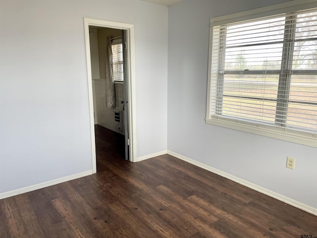 empty room with dark hardwood / wood-style floors