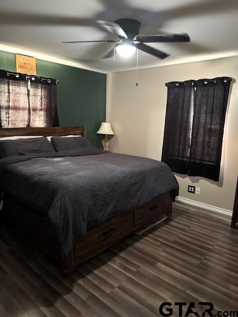 bedroom with wood finished floors, baseboards, and ceiling fan