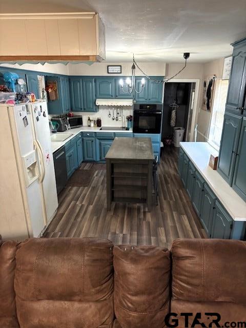 kitchen featuring blue cabinetry, black appliances, dark wood finished floors, and light countertops