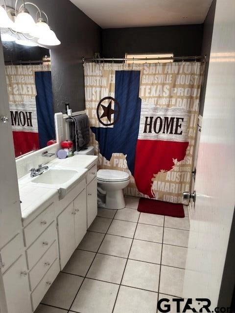 full bathroom with tile patterned floors, toilet, and vanity