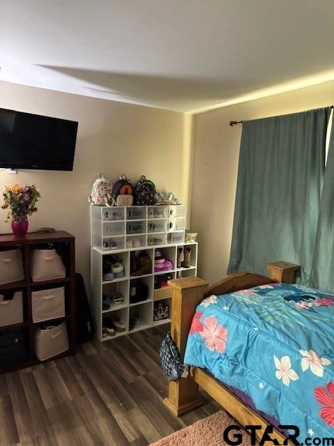 bedroom featuring wood finished floors