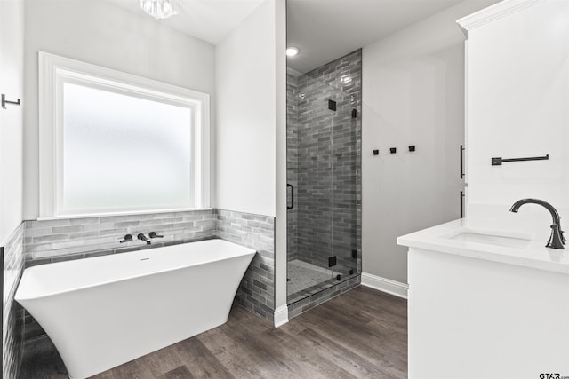 bathroom featuring shower with separate bathtub, vanity, and hardwood / wood-style flooring