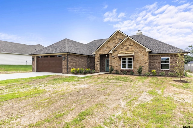 view of front of property featuring a front yard and a garage