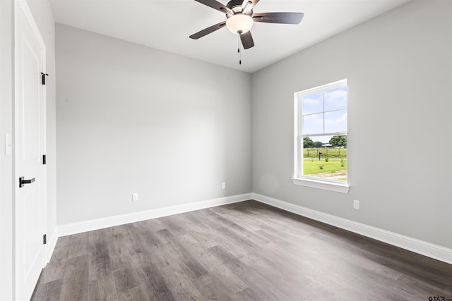 spare room with hardwood / wood-style floors and ceiling fan