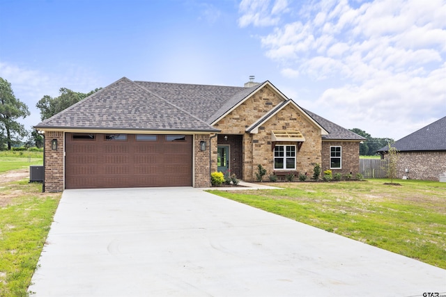 view of front of house with a front lawn and a garage