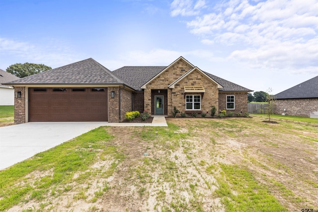 view of front of house featuring a front yard and a garage