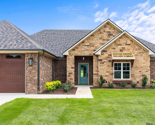 view of front facade with a front yard and a garage