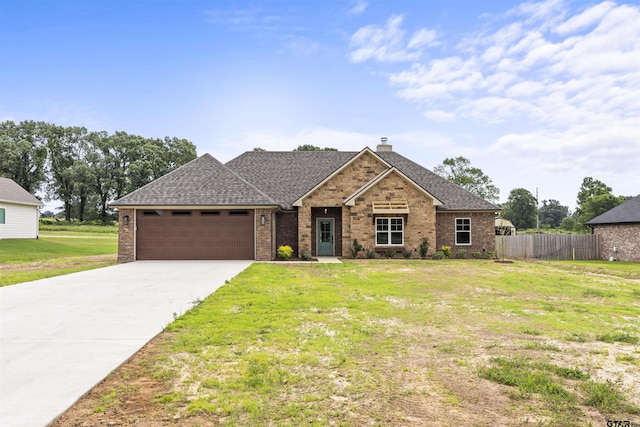 view of front of home with a garage and a front yard